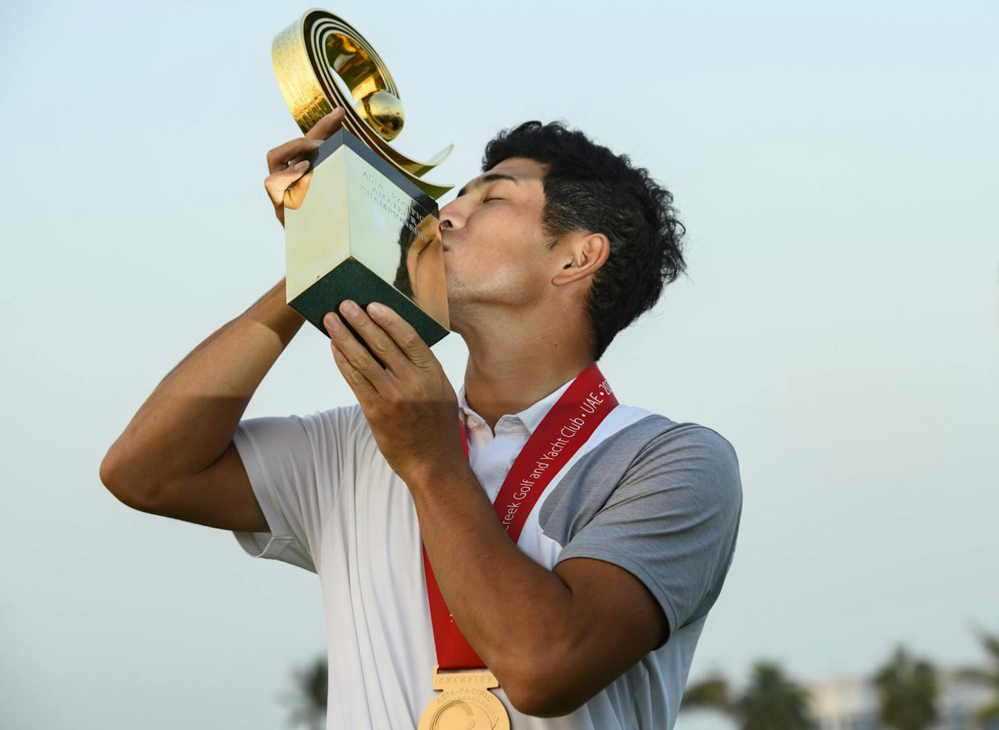 Keita Nakajima of Japan kisses the AAC trophy