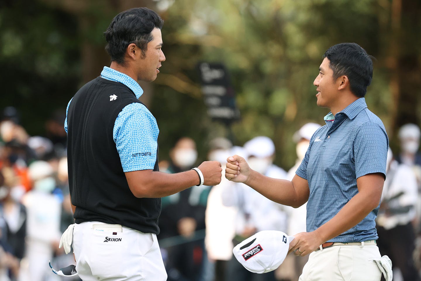 C.T. Pan (R) of Chinese Taipei and Hideki Matsuyama (L) of Japan fist bump after holing out on the 18th green during the first round of the ZOZO Championship at Accordia Golf Narashino Country Club on October 21, 2021 in Inzai, Chiba, Japan. (Photo by Atsushi Tomura/Getty Images)