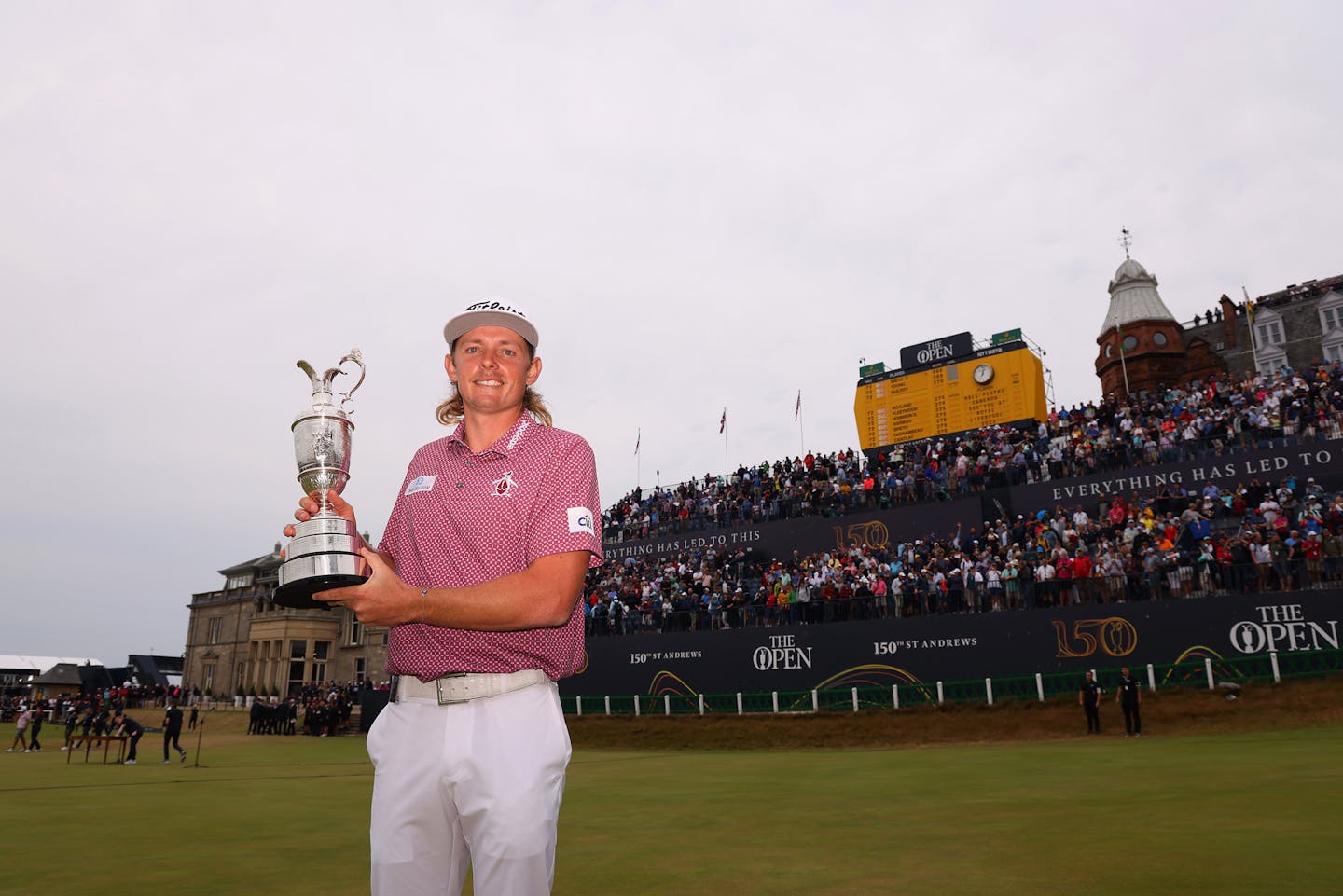 ST ANDREWS, SCOTLAND - JULY 17: Cameron Smith of Australia poses with The Claret Jug in front of the 18th hole grandstand during Day Four of The 150th Open at St Andrews Old Course on July 17, 2022 in St Andrews, Scotland. (Photo by Richard Heathcote/R&amp;A/R&amp;A via Getty Images)