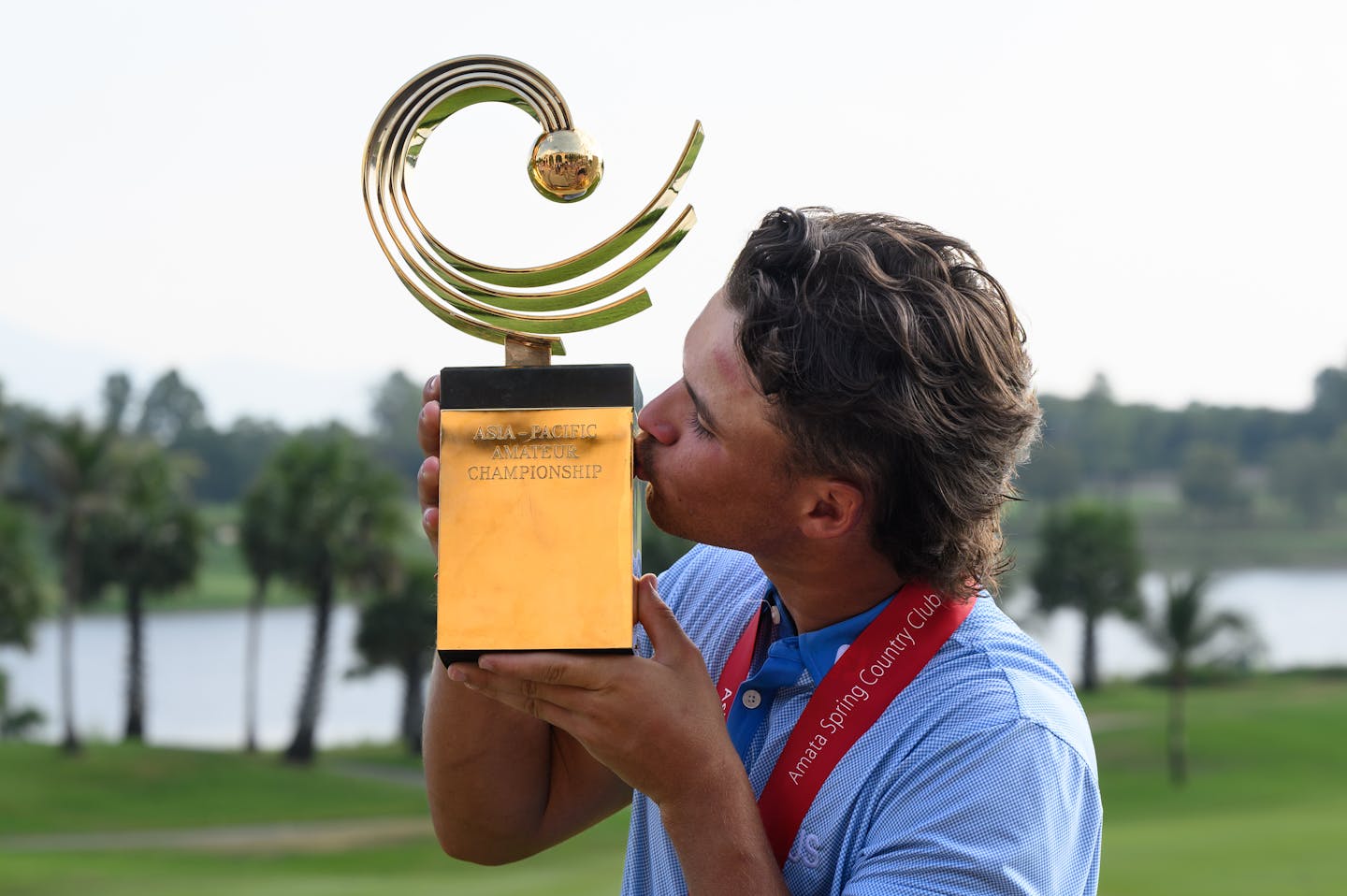 Harrison Crowe of Australia kisses the Asia-Pacific Amateur Championship trophy