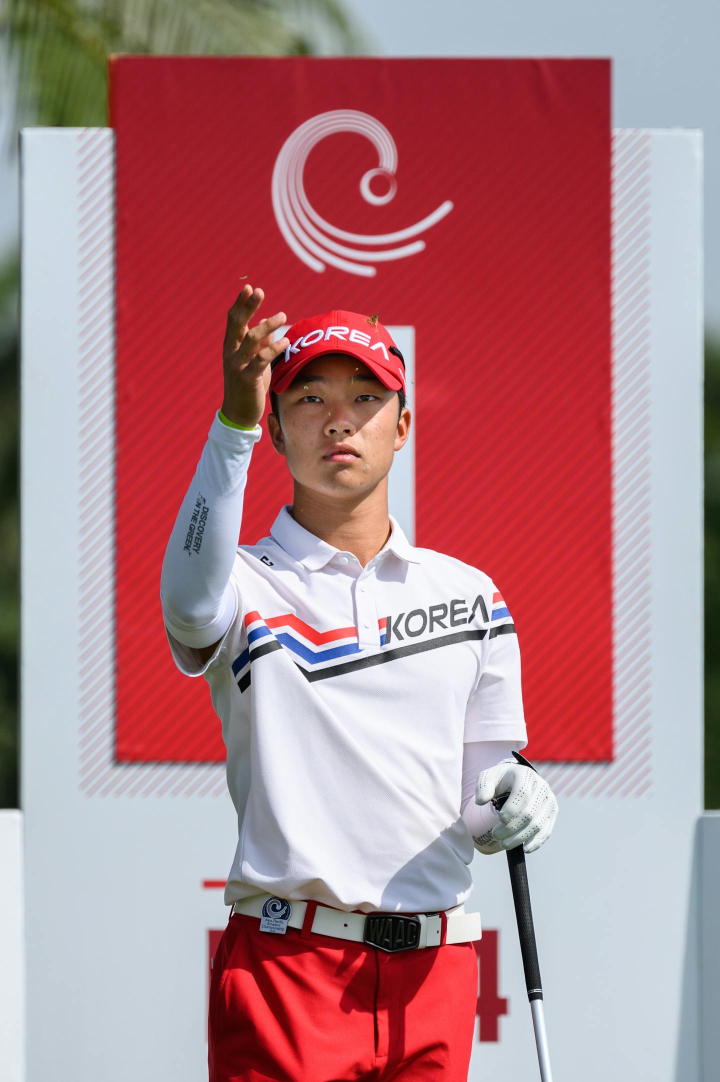 Minhyuk Song of Korea checks the wind on the 1st tee