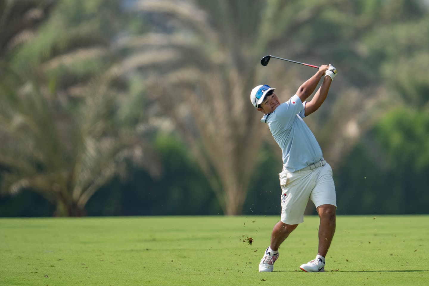Taisei Nagasaki of Japan plays a stroke from the fairway on the No. 13 hole